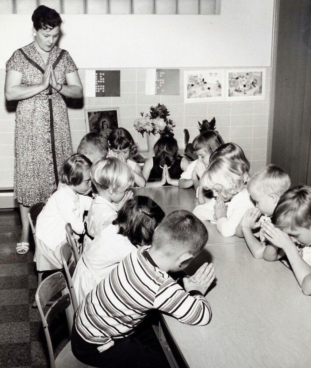 Teacher and Children Praying in School